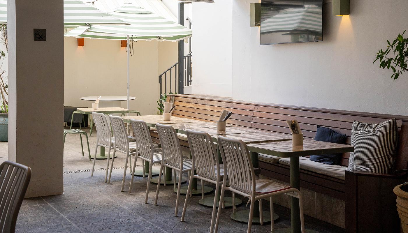 The courtyard under green striped umbrellas