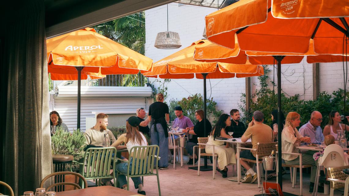 The courtyard under orange Aperol umbrellas