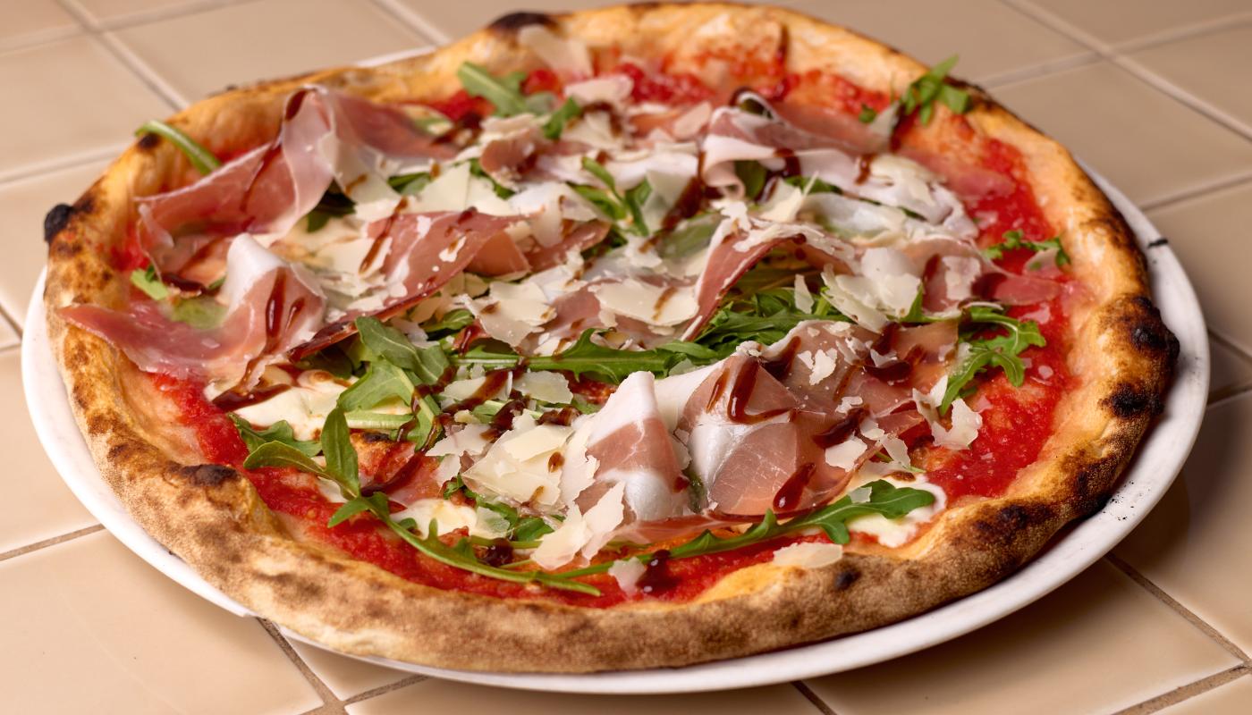 Wood-fired prosciutto pizza from the trattoria