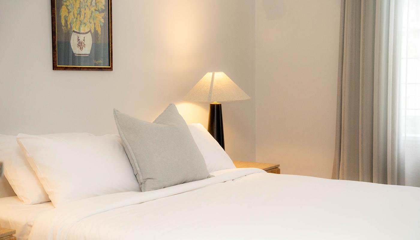 Bedroom with wildflower artwork and lamplight